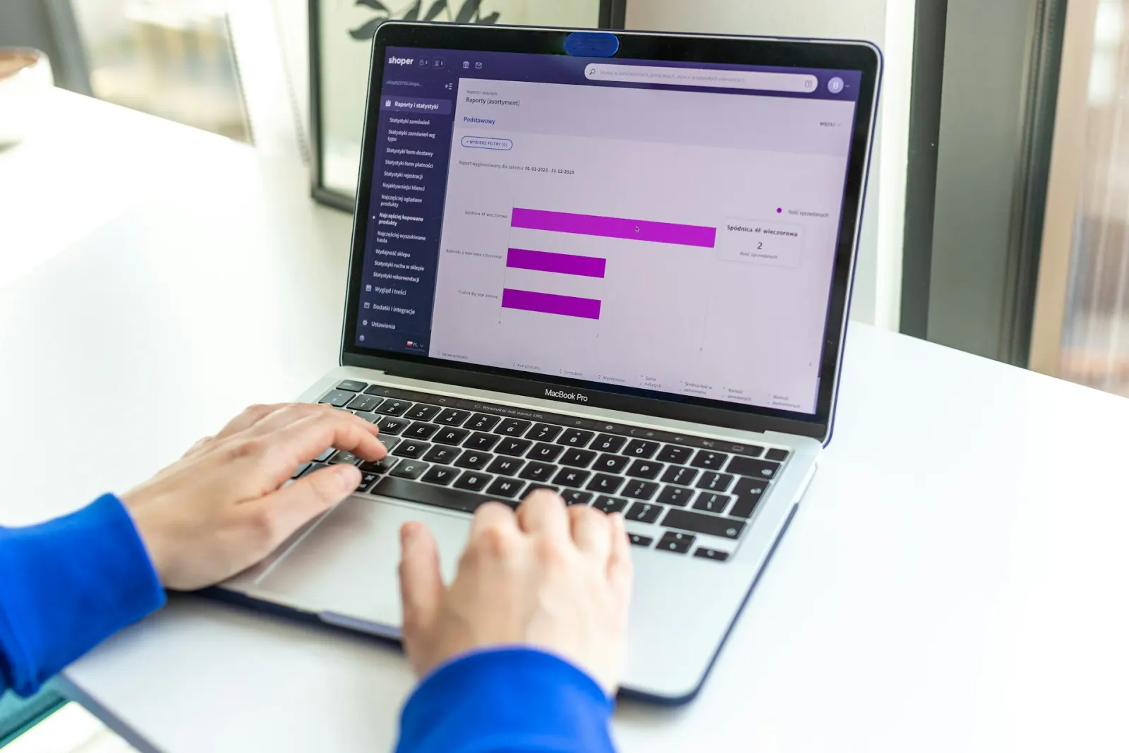 Hands typing on a laptop showing a bar chart comparison, representing a shopper comparing insurance quotes before deciding who to buy from.